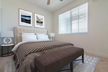 Bedroom with window view at Portola Senior Apartments, Carlsbad, California